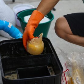 A,Man,Cleaning,A,Grease,Traps,Box,Outside,The,House,