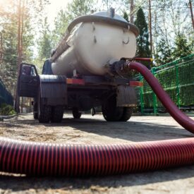 Close-up,Pipe,Hose,Of,Sewage,Truck,Car,Engine,Emptying,Home