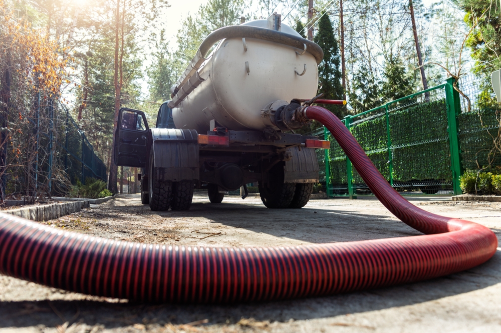 Close-up,Pipe,Hose,Of,Sewage,Truck,Car,Engine,Emptying,Home