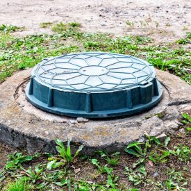 Covered,Sewer,Manhole,Of,Rural,Septic,Tank,With,Green,Plastic