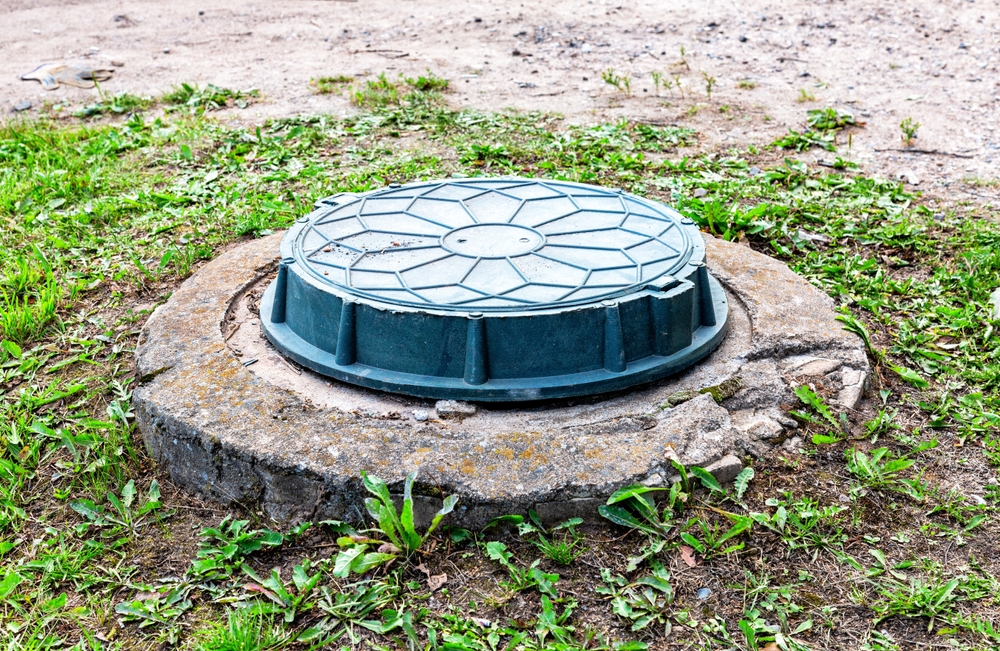 Covered,Sewer,Manhole,Of,Rural,Septic,Tank,With,Green,Plastic